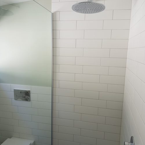 Subway tiles and wall mounted shower head