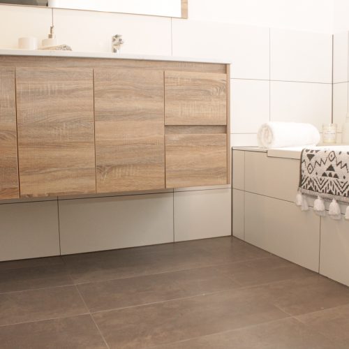 Bath with double vanity and white wall tiles