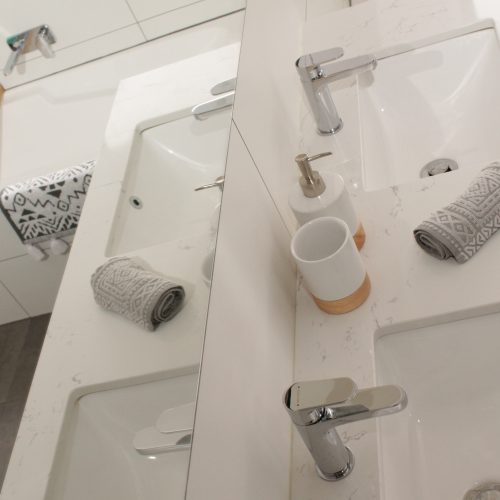 White stone top vanity with Methven tapware