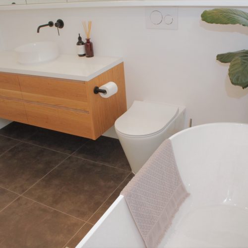 freestanding bath with Custom made timber vanity and toilet
