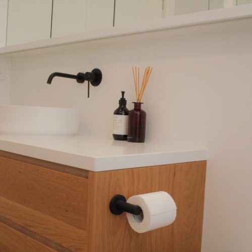 Custom made timber vanity with matte black wall mounted mixer and spout